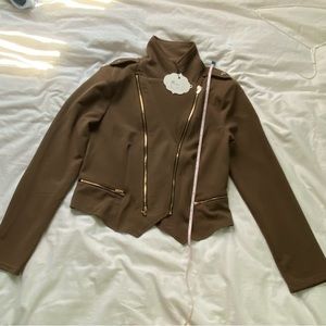 Lightweight ACTIVE USA jacket is unlined and is 92 % polyester and 8% spandex.